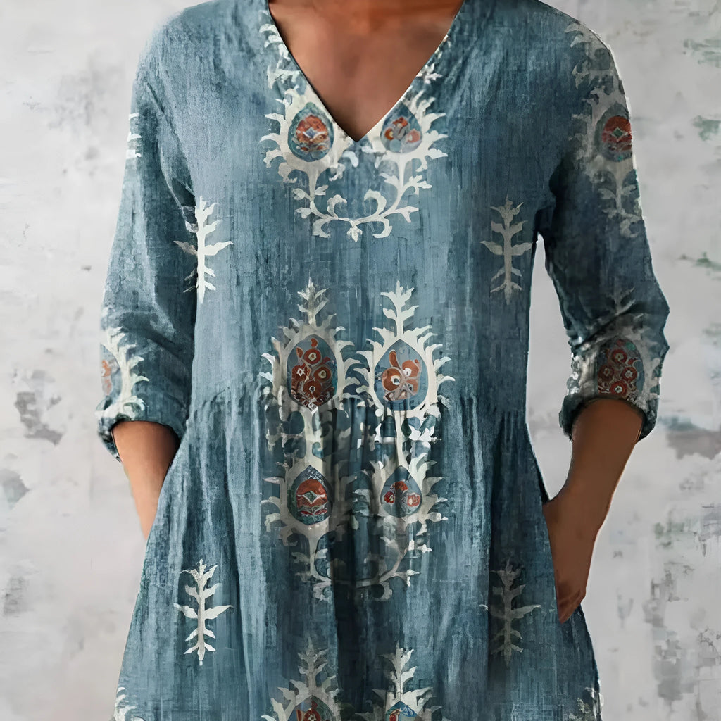 Women's printed wave-pattern loose dress with wide waist and three-quarter sleeves on a mannequin.