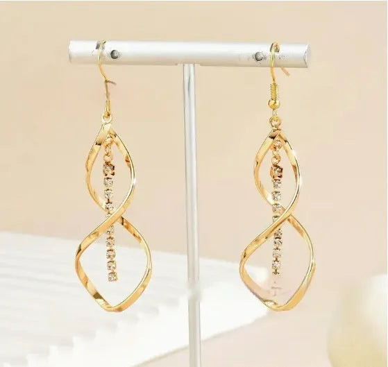 Women's gold geometric earrings with spiral design and diamond shape on alloy construction