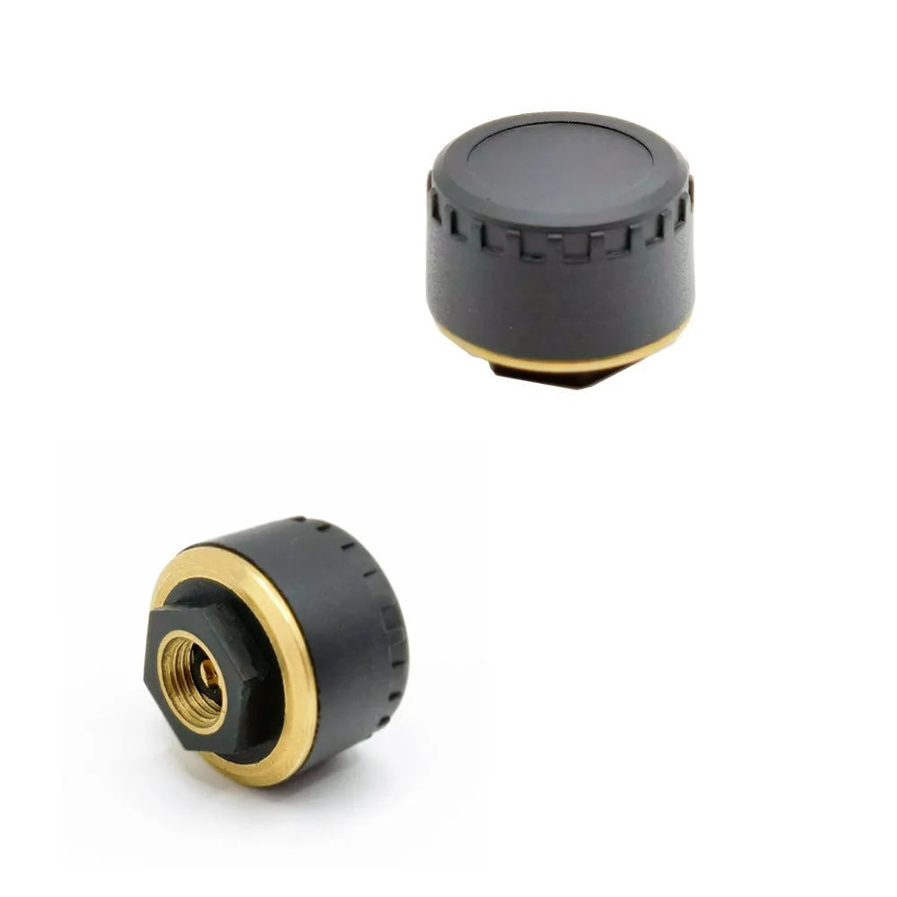 Four black Bluetooth tyre pressure sensors for car wheel monitoring via mobile phone app