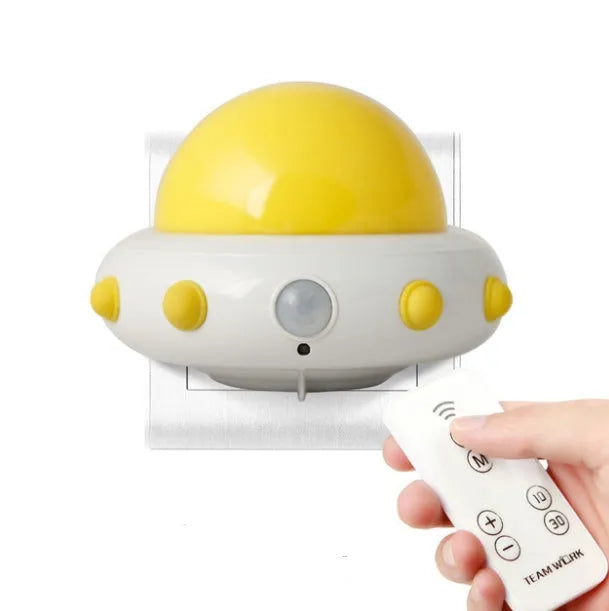 Remote control UFO-shaped bedside night light in blue, pink, or white with cartoon modern design