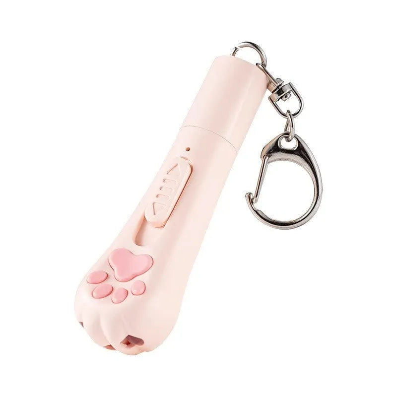 Pink automatic cat teaser toy with a wand attachment on a hardwood floor, showing compact circular base.