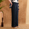 Women's linen high-waist trousers with a loose straight-leg cut and elasticated waistband in greige.