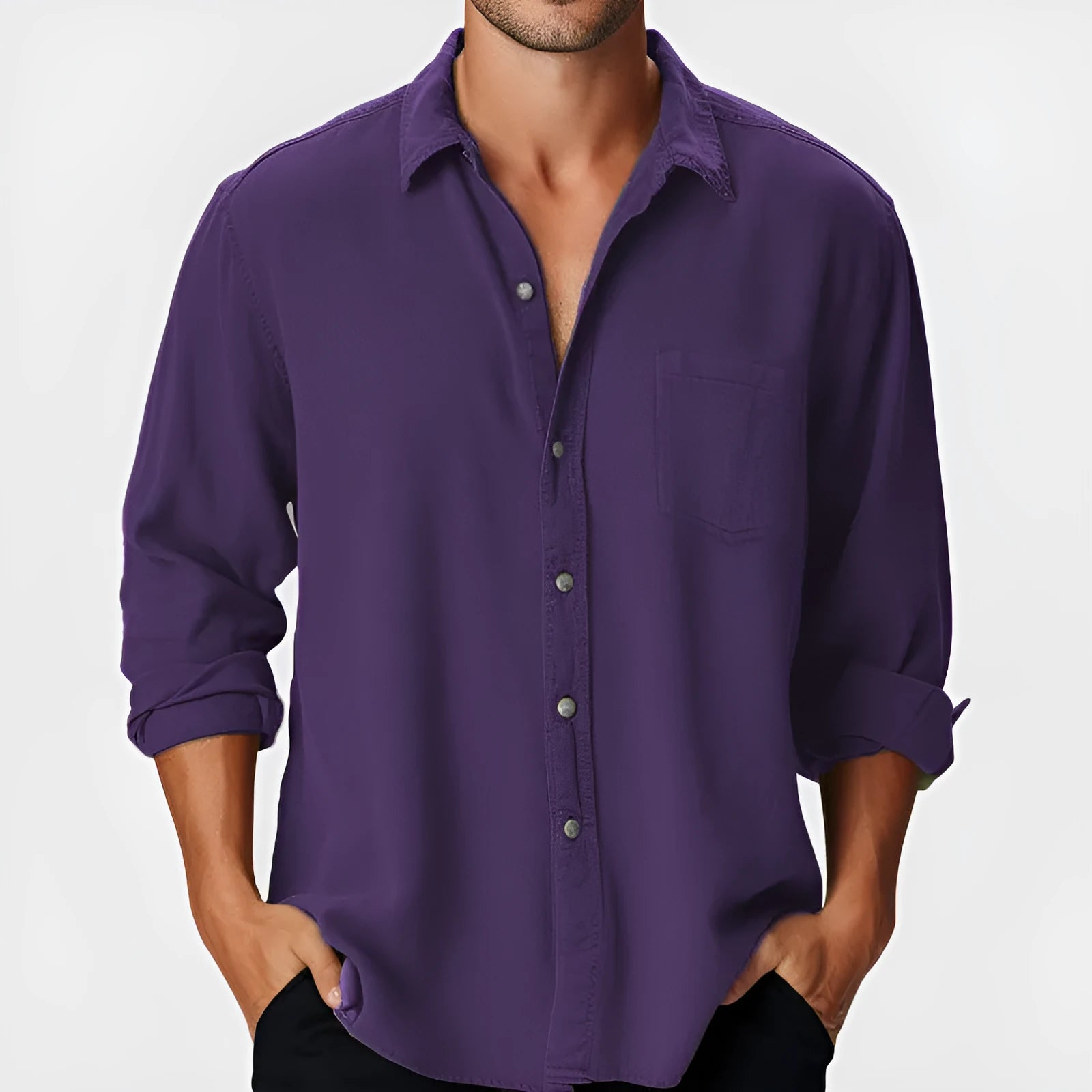 Man wearing a solid colour loose-fit long sleeve shirt with a stand collar.