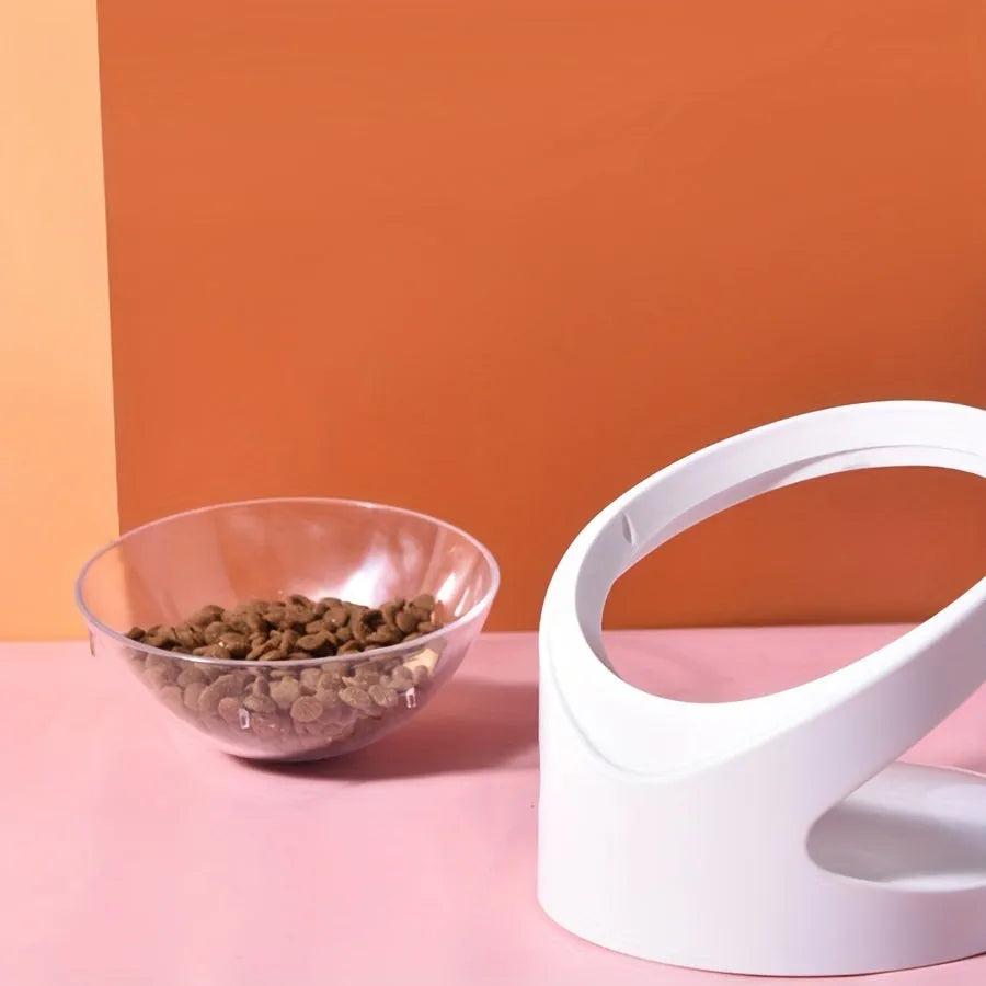 White clear plastic elevated cat food bowl with tilted ergonomic design for neck protection.