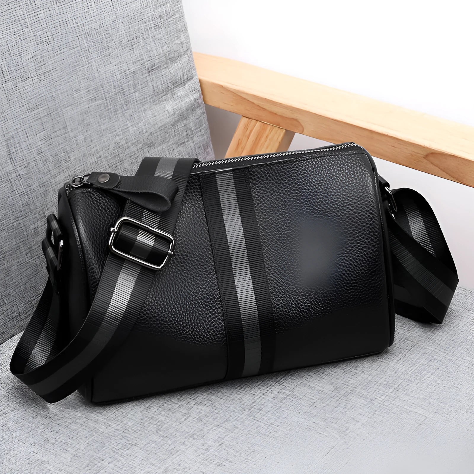 Black genuine leather one-shoulder crossbody bag showing its large capacity and strap.