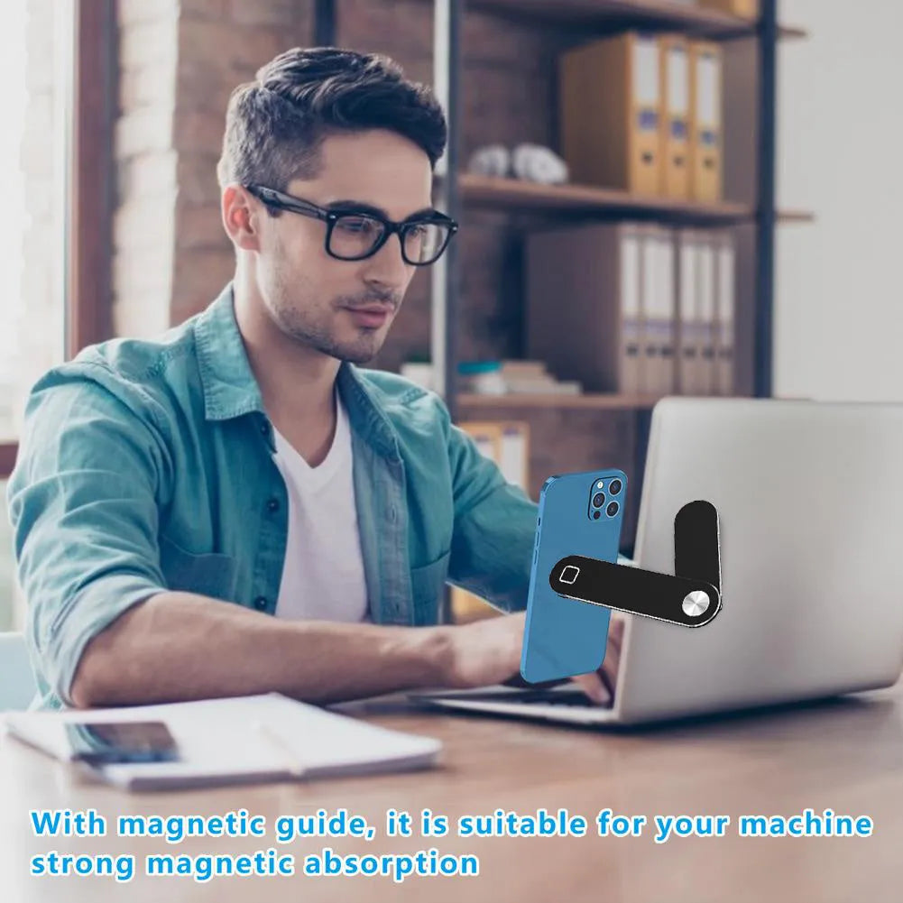 Black aluminium laptop phone holder with magnetic mount attached to laptop side displaying smartphone