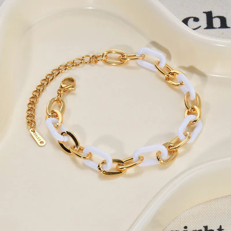 Women's adjustable stainless steel bracelet with a double-layered resin heart charm.