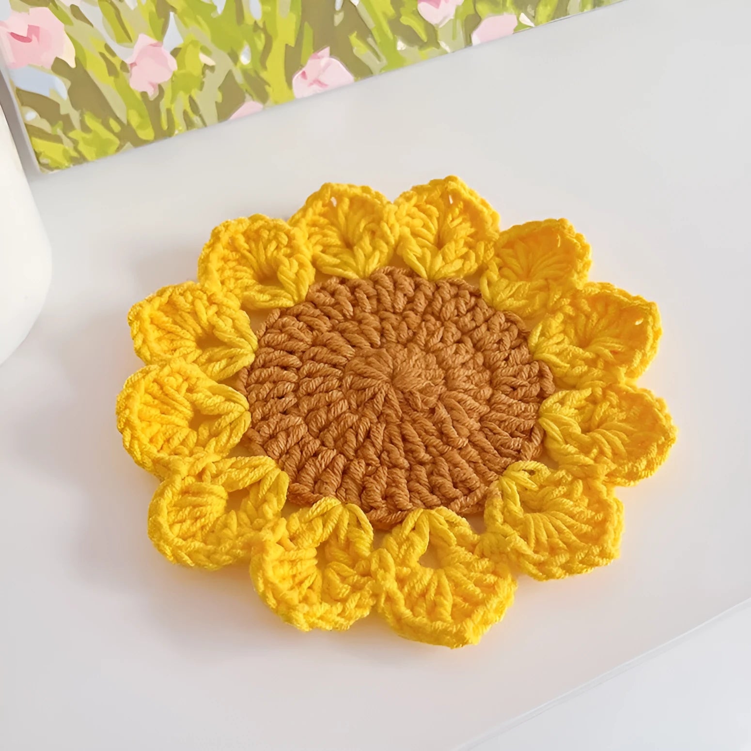 Hand-woven wool flower coaster set showing textured surface and floral pattern