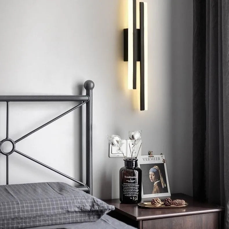 Minimalist Scandinavian-style LED wall light with acrylic shade in black or gold finish