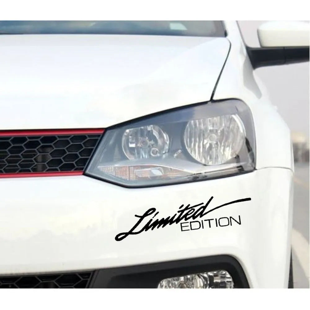 A black, white, and colourful British style reflective plastic bumper sticker, shown at its 16cm by 3.8cm size.
