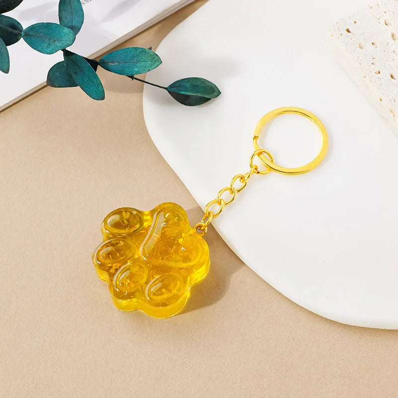 Small natural crystal cat's paw pendant on a metal keyring, available in various stone colours.