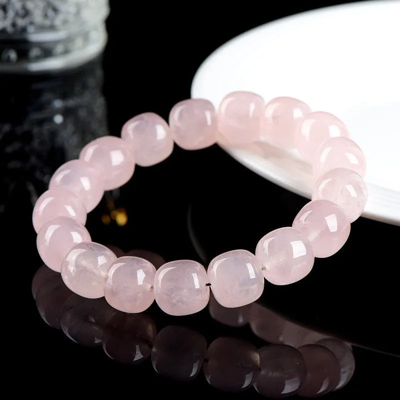 Pink natural bamboo crystal barrel bead bracelet with 11x12mm beads and geometric design.