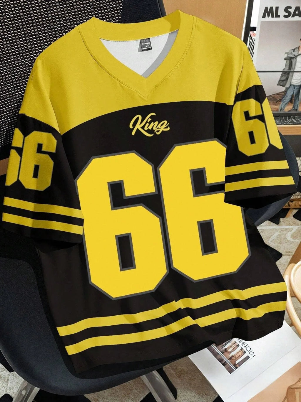 Man wearing a loose grey t-shirt with a large Chicago No. 23 digital print on the front.