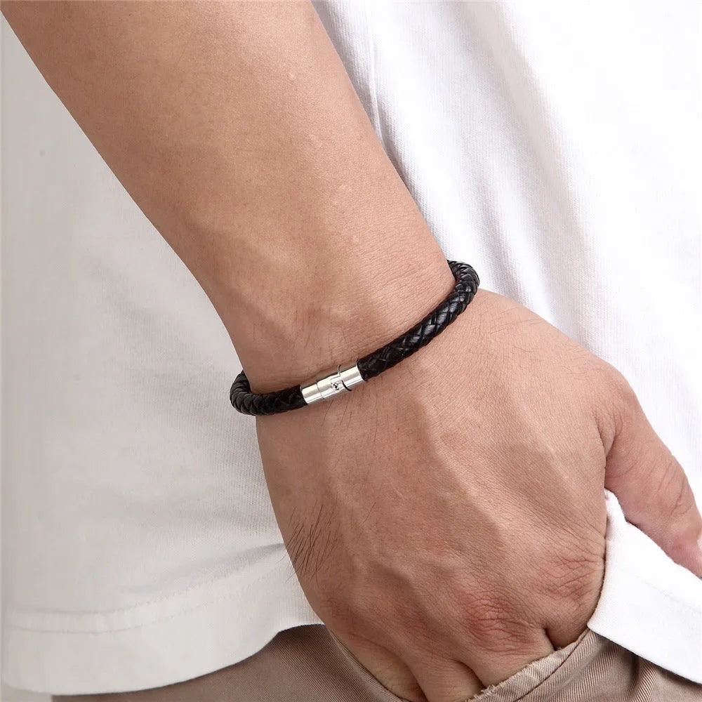 Geometric titanium steel wire bracelet with a magnetic clasp closure on a wrist.
