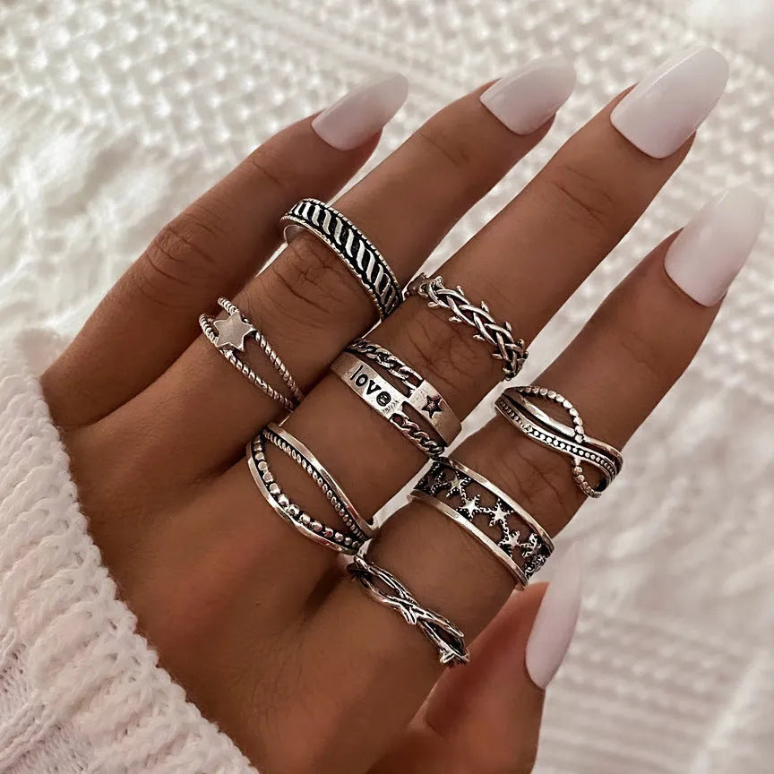 Alloy ring set with butterfly and snake retro geometric designs on display
