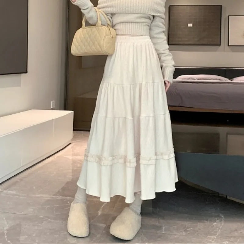 Corduroy A-line midi skirt with elastic waistband in milky white, shown on a hanger.