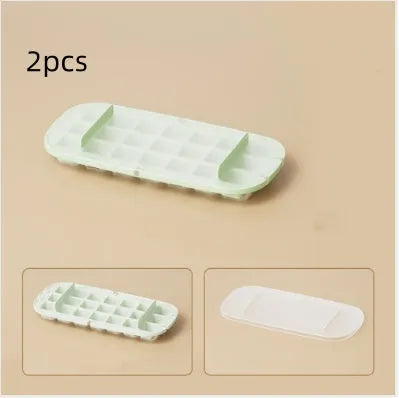 Blue high-capacity ice cube tray with silicone lid and ice scoop stored in its dedicated slot.