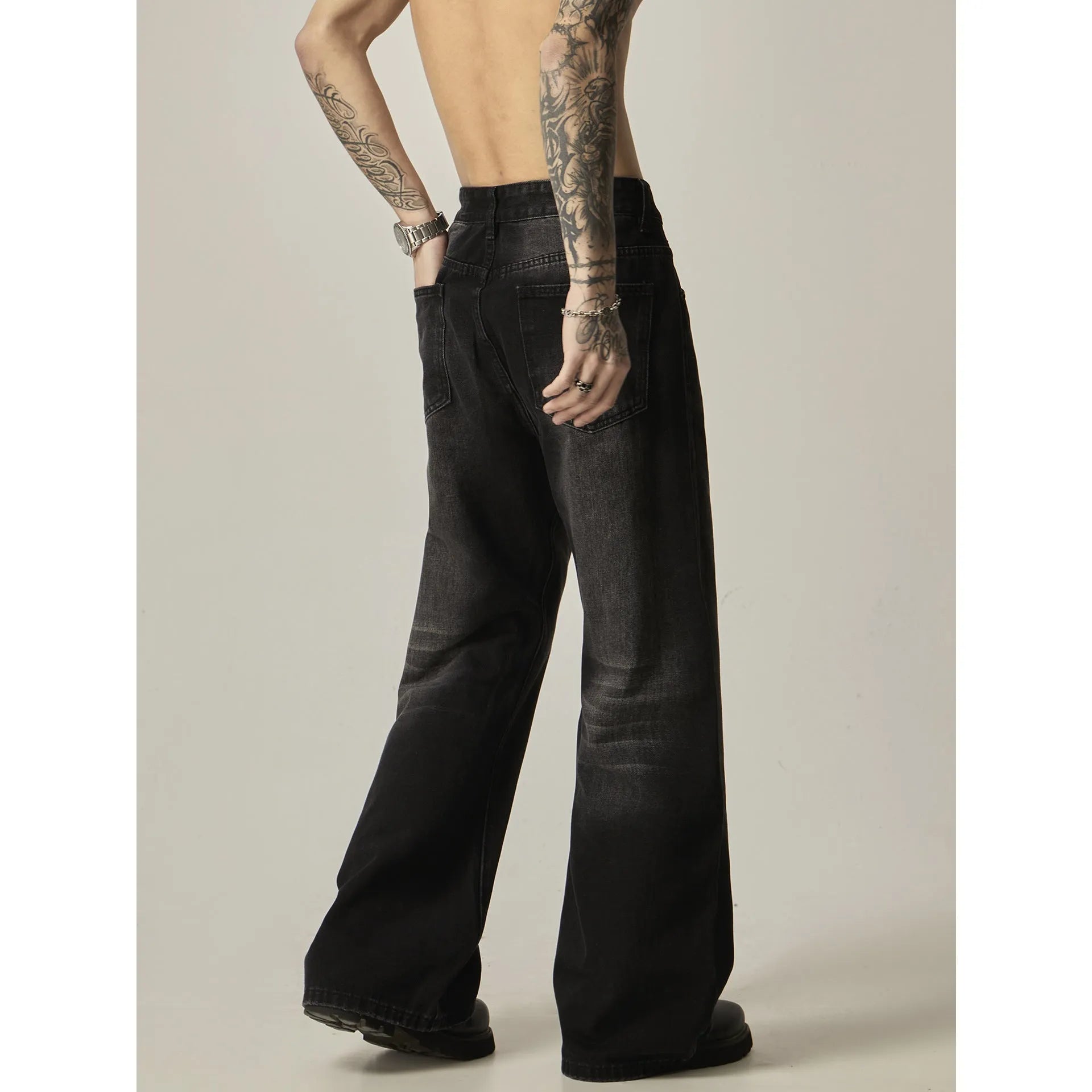 Man's black loose-fit straight-leg retro jeans made from polyester denim fabric.