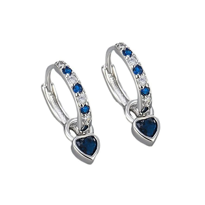 Women's heart-shaped earclip earrings with a coloured zircon or stone centre, in gold or white gold colour.