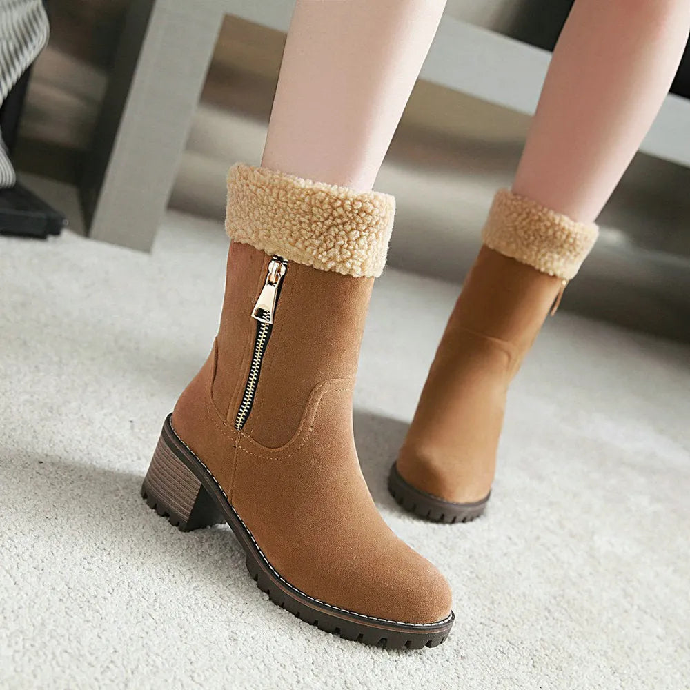 A pair of ankle-height snow boots in black, shown with a short plush lining and rubber sole, on a white background.