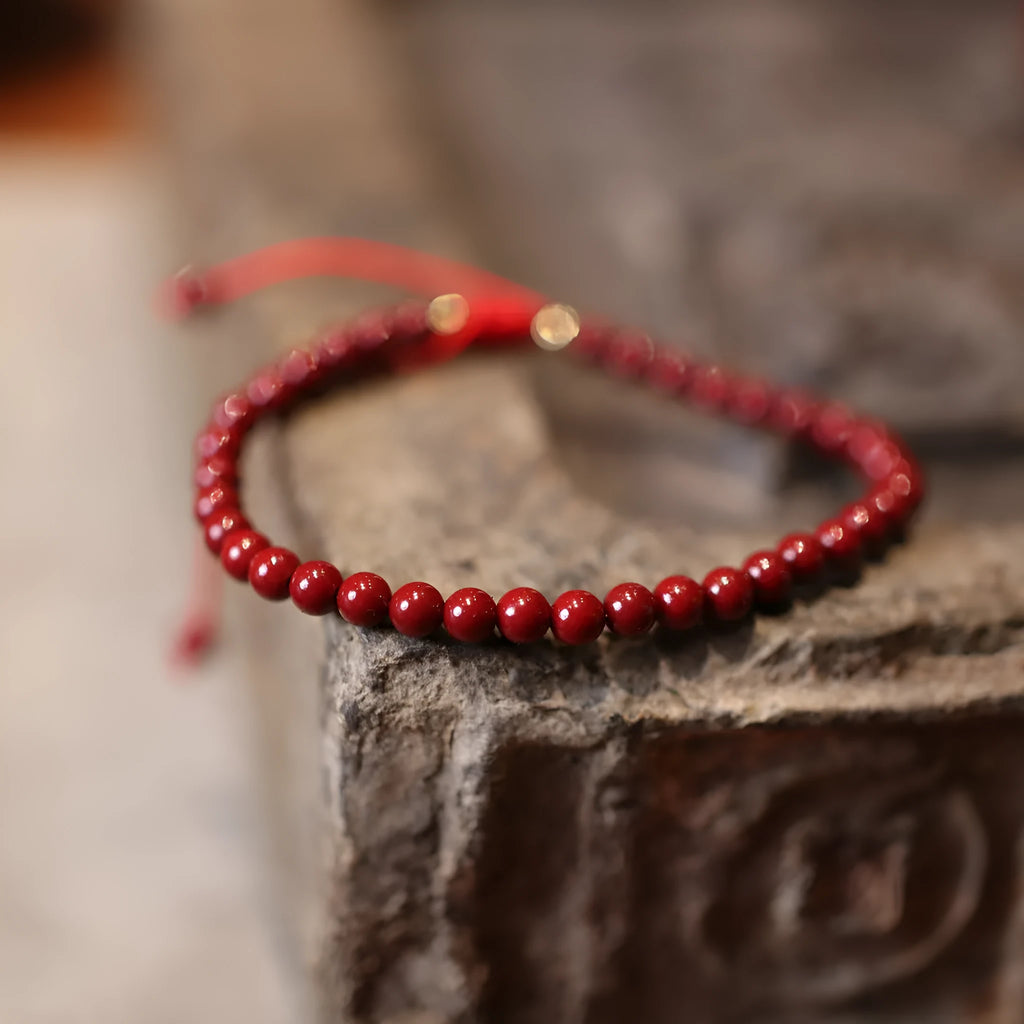 Women's handmade cinnabar bracelet with purple gold sand design and Chinese auspicious patterns.