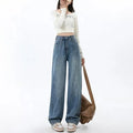 Women's retro blue high-waist wide-leg denim trousers on a hanger, showing straight leg cut.