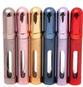 Refillable aluminium travel perfume atomiser with glass liner in blue, gold, pink, red, silver, or violet.