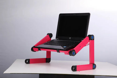 Black folding laptop table stand with six legs, magnesium alloy desktop, and attached mouse pad, folded view on a desk