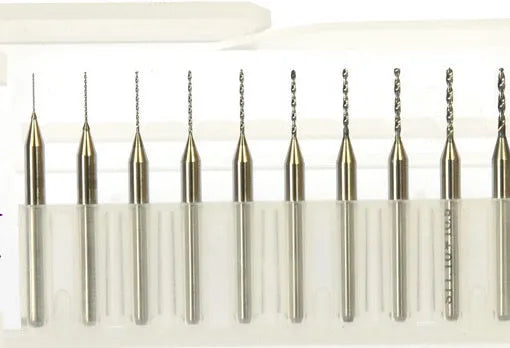 Close-up of a set of fine tungsten steel micro-engraving bits with diameters from 0.10mm to 2.00mm on a grey background.