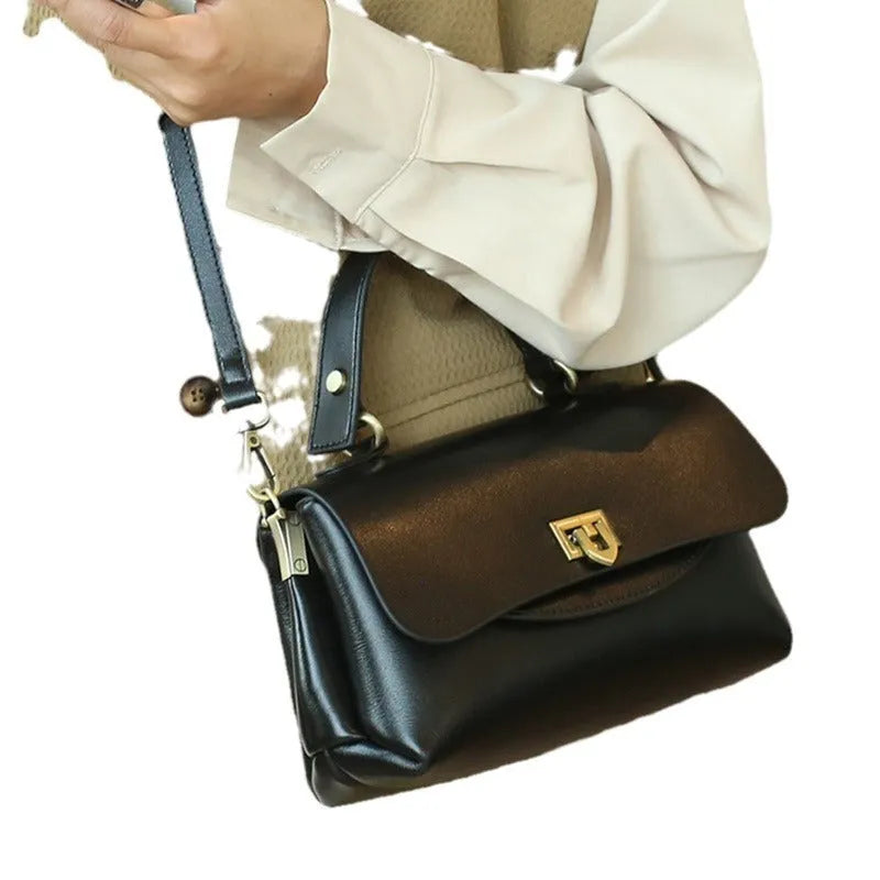 Brown retro style women's leather handbag with saddle back shape and double shoulder straps