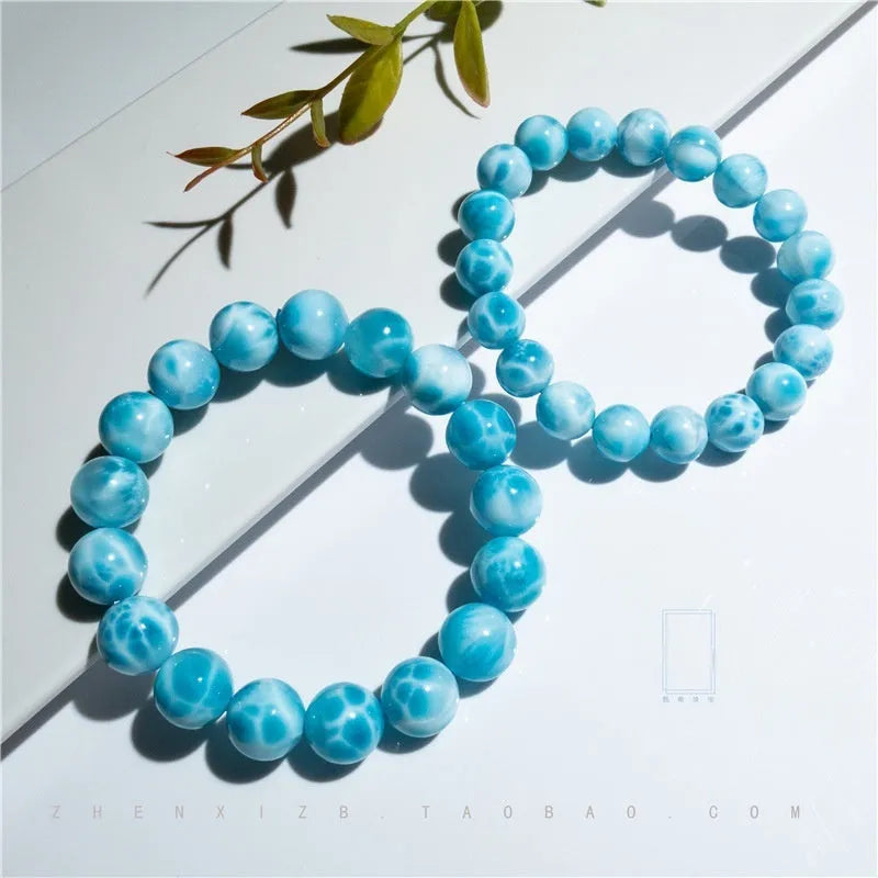 Blue hand-crafted bodhi bracelet with a pearl accent, showing bead sizing options.
