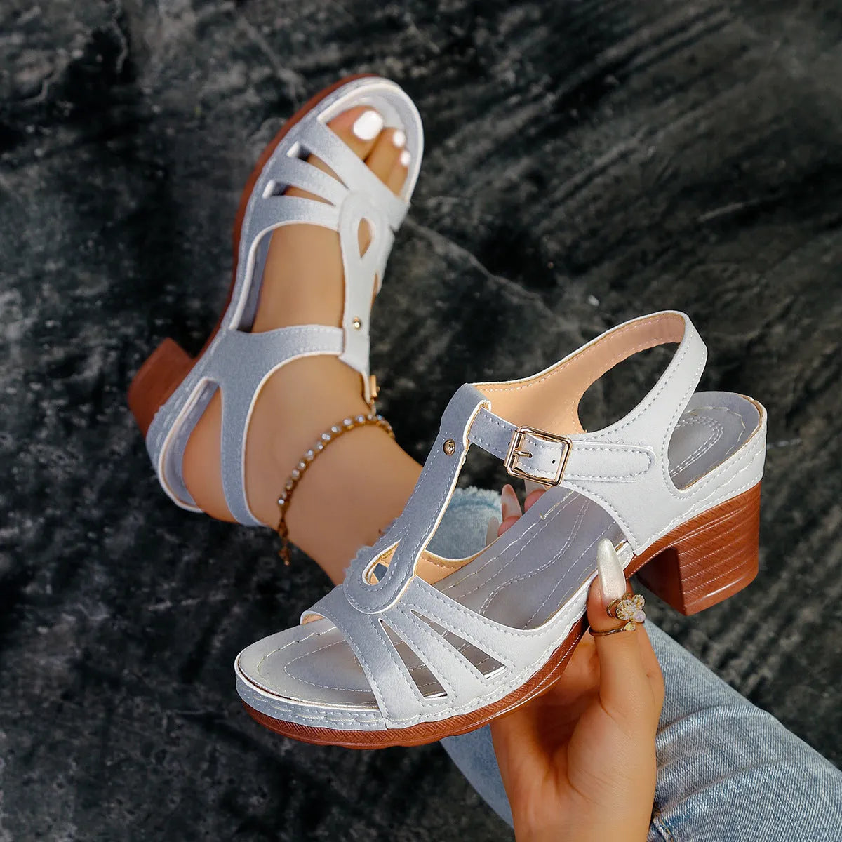 Women's black peep toe wedge sandals with a buckle strap on a polyurethane sole.