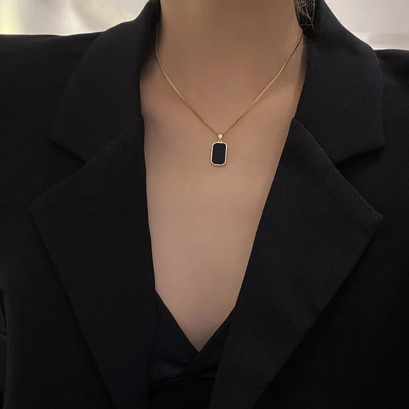 Rectangular pendant necklace in 18K gold plated titanium steel with box chain, black geometric design, 41-50cm.