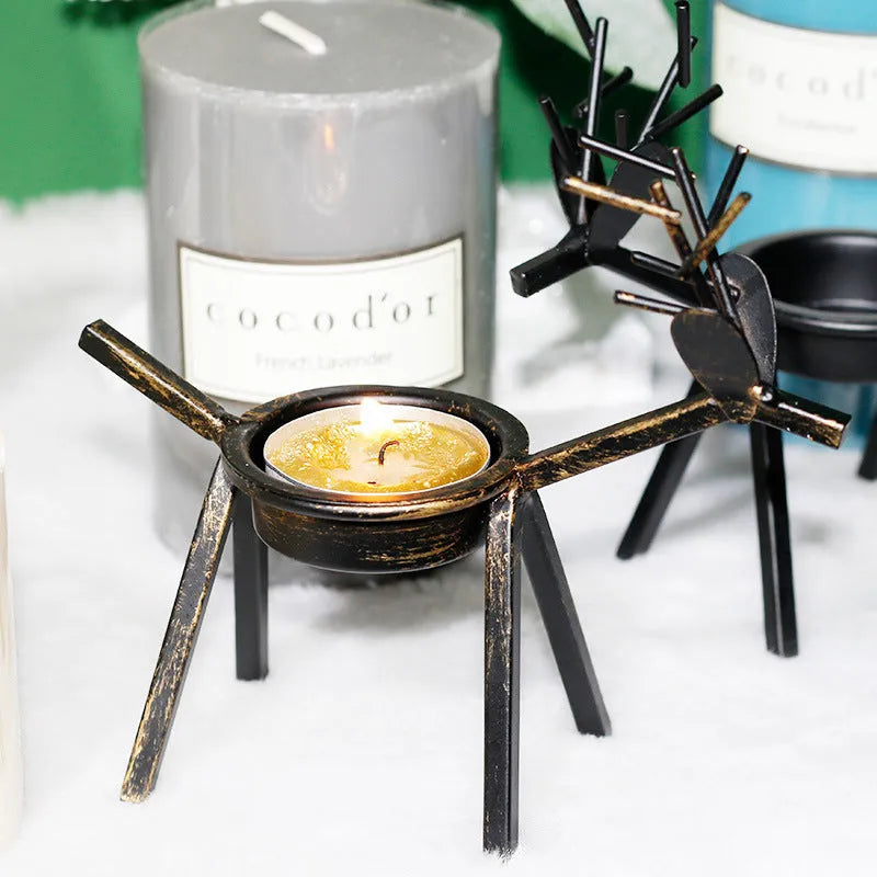 Black iron Christmas candlestick holder with decorative elk bracket design.