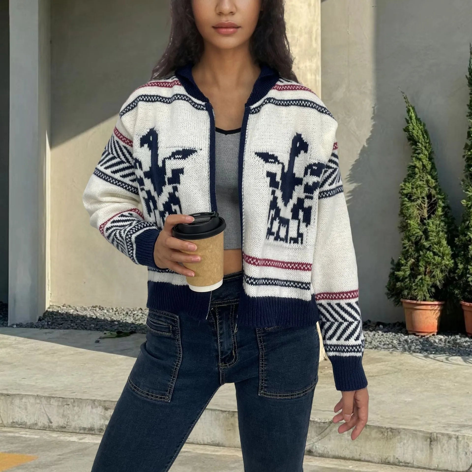 White women's zip-front cardigan with lapel collar and contrasting jacquard stripe pattern.