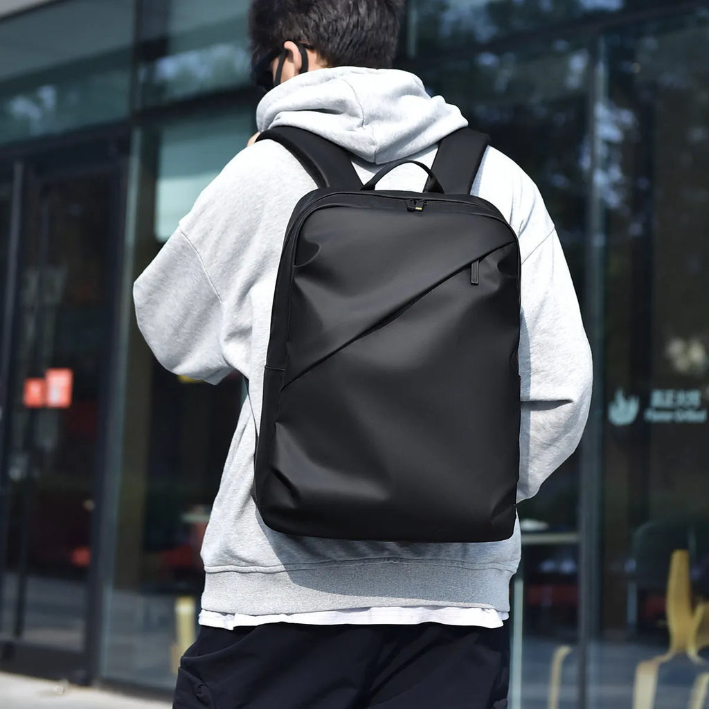 Waterproof PU leather laptop backpack in black, blue or grey with large capacity and laptop compartment