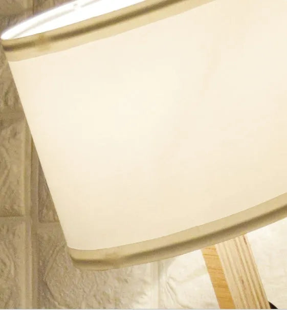 Creative humanoid wooden table lamp with white fabric shade measuring 22x44x16cm