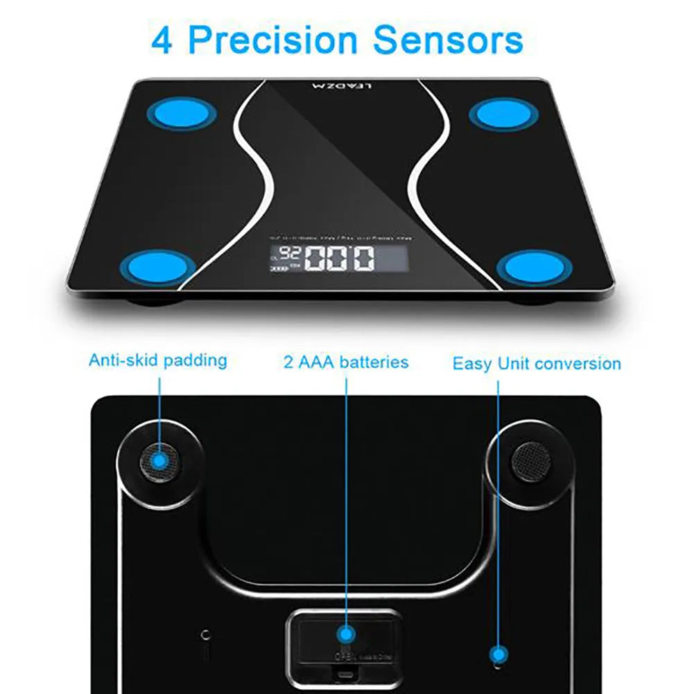 A black electronic body scale with a digital display on a hard floor.