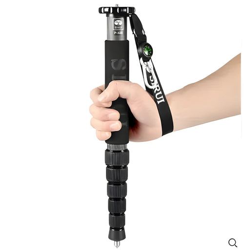 Black carbon fibre SLR camera monopod fully extended, showing its 6-section telescopic design.
