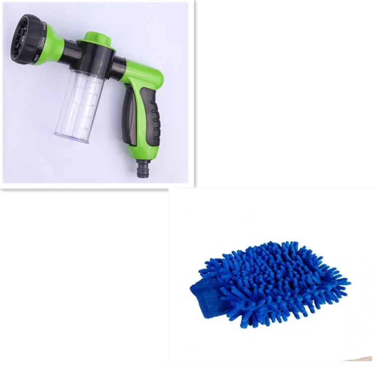 Green high-pressure foam spray gun with adjustable nozzle and attached water hose for car and garden cleaning.