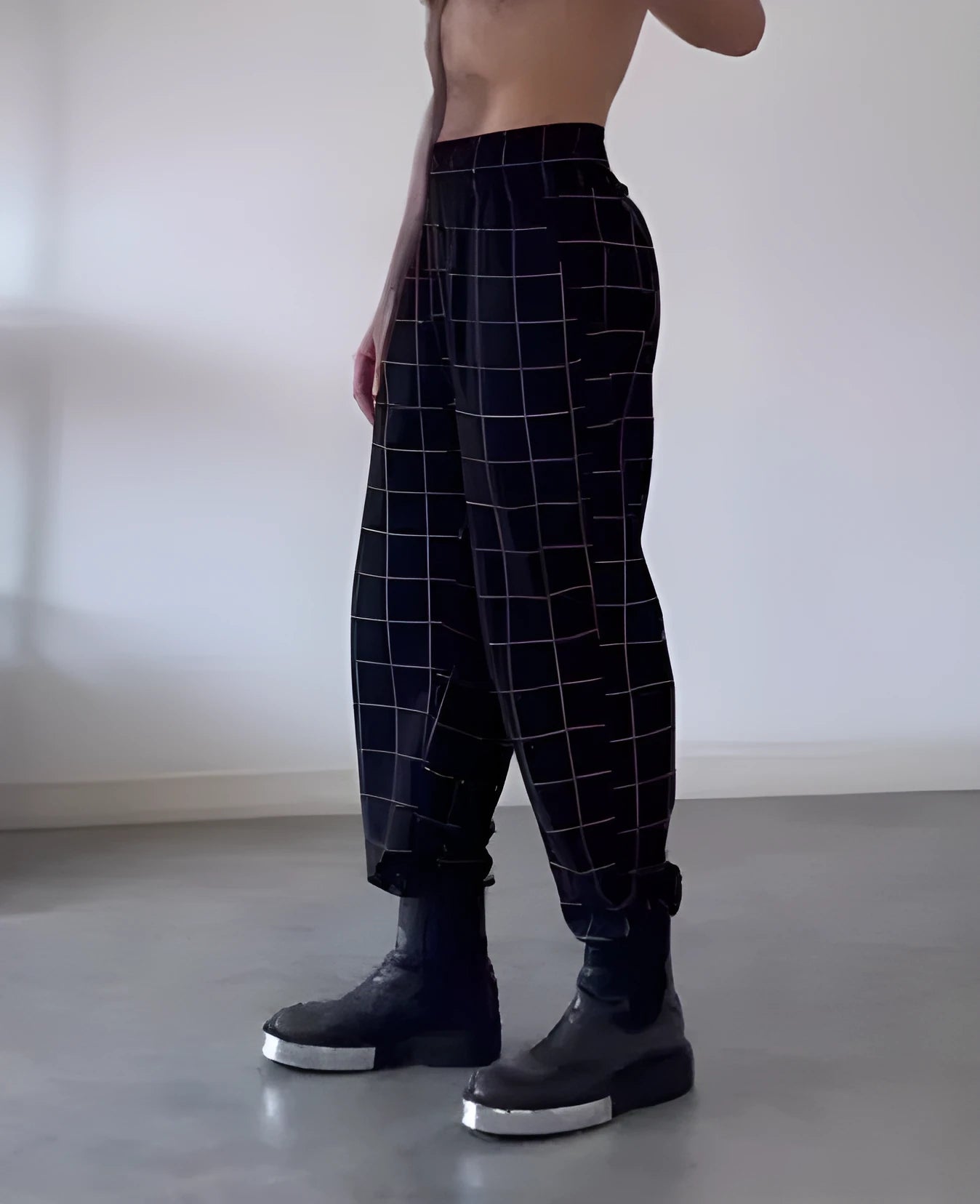Men's plaid trousers with an apron-style front panel, shown on a model.
