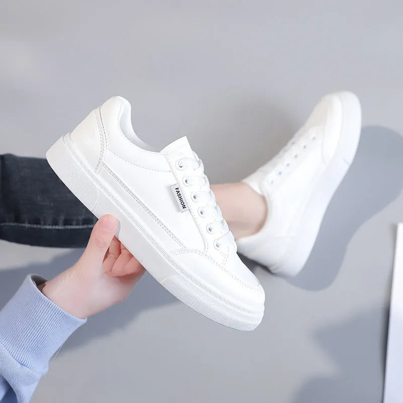 Korean style women's low-top sneakers in white or brown artificial PU with plastic sole.