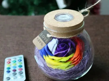 Colorful rose soap flower in glass wishing bottle with four colour options for decor or gift