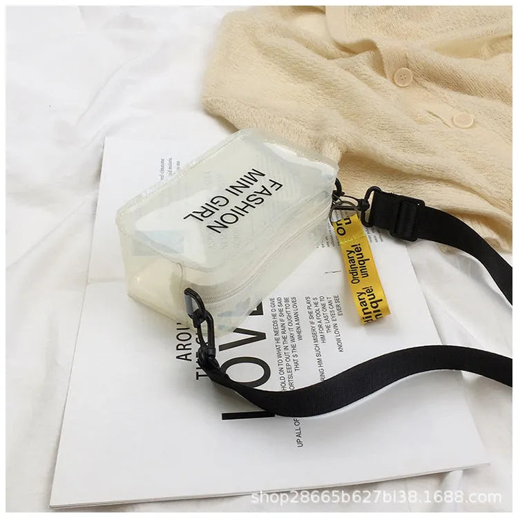 Transparent square jelly women's shoulder bag with a long adjustable strap, shown in a light colour.