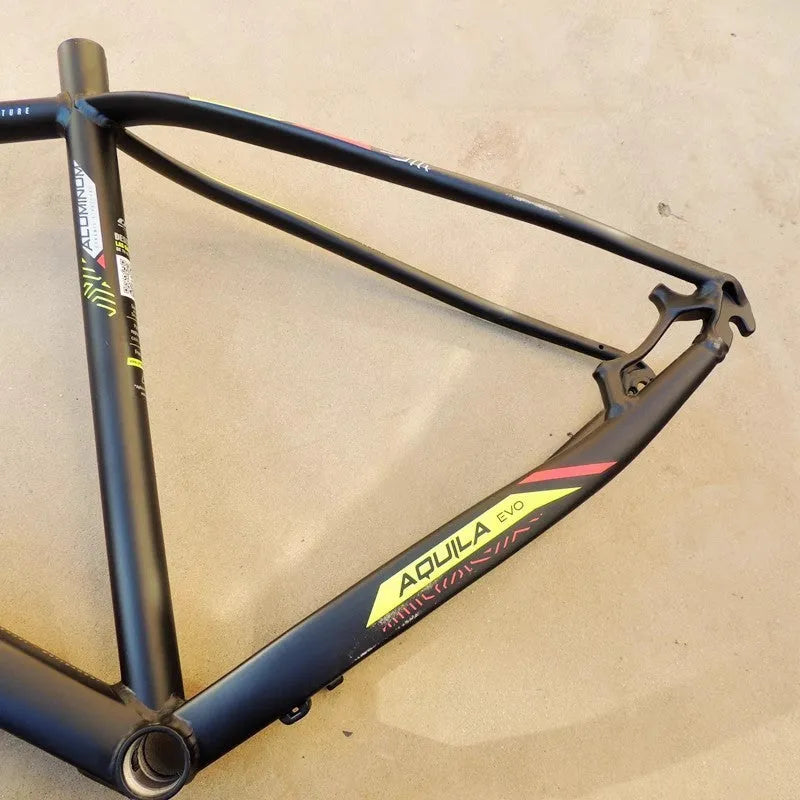 29-inch black green aluminium mountain bike frame showing inner cable routing ports and disc brake mount