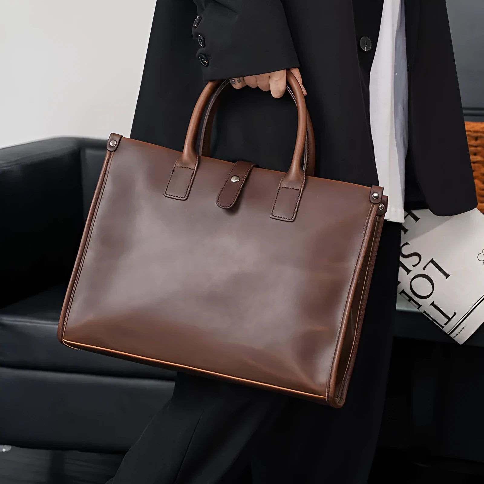 Brown men's messenger bag with soft PU surface and multiple compartments on a flat surface