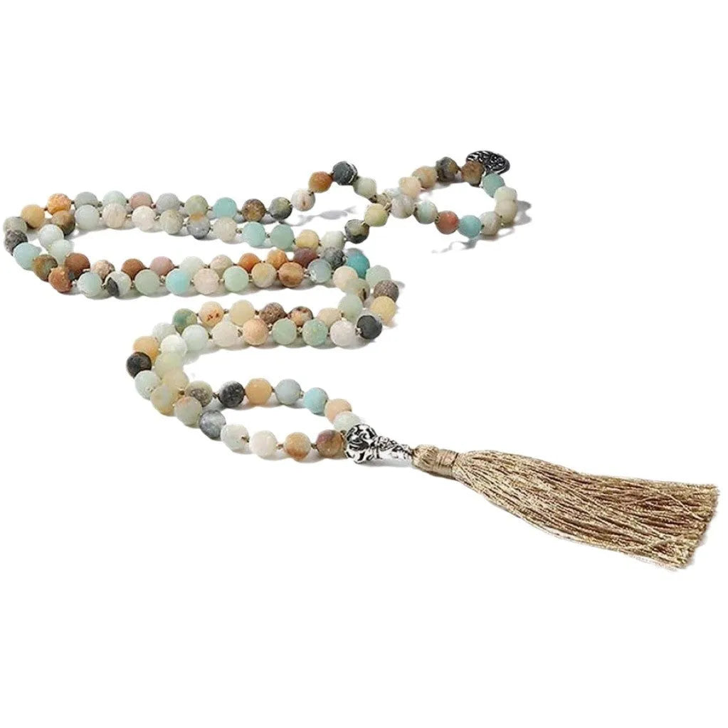 Long handmade necklace with 108 small round stone beads on a black cord, shown doubled up.