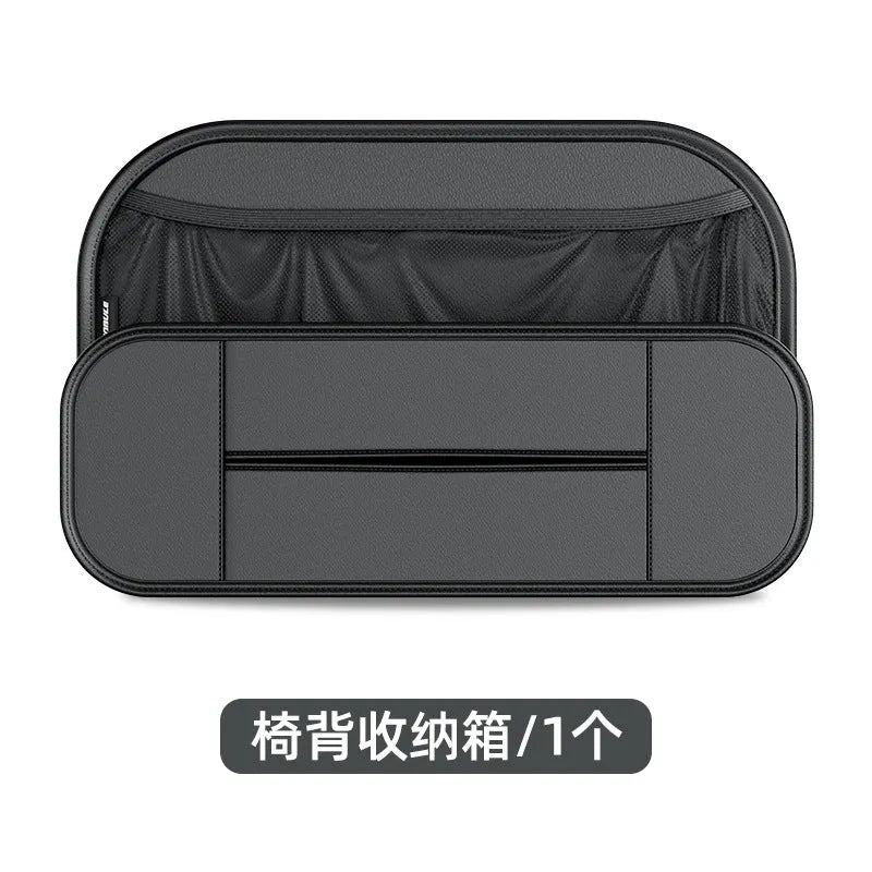 Black leather car seat rear storage bag with compartments, shown mounted on a car seat.