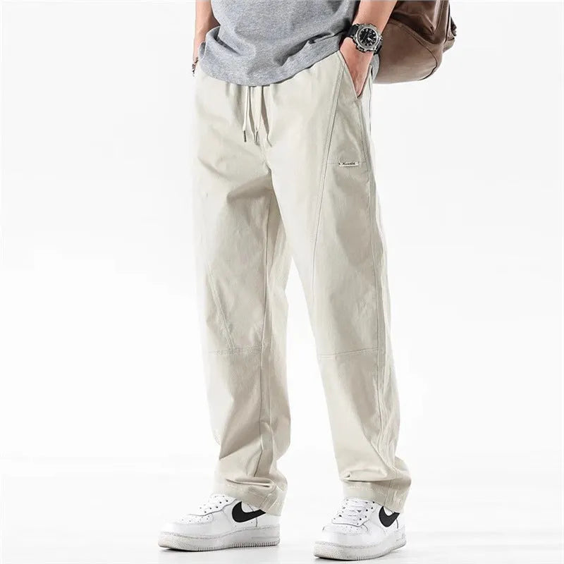 Casual wide-leg cotton trousers in milky white on a model, showing the relaxed fit and trousers-mouth silhouette.