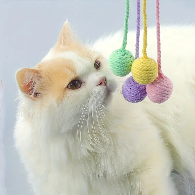Cat toy ball with rope attachment and bell inside, shown in green, pink, purple, and yellow colour options